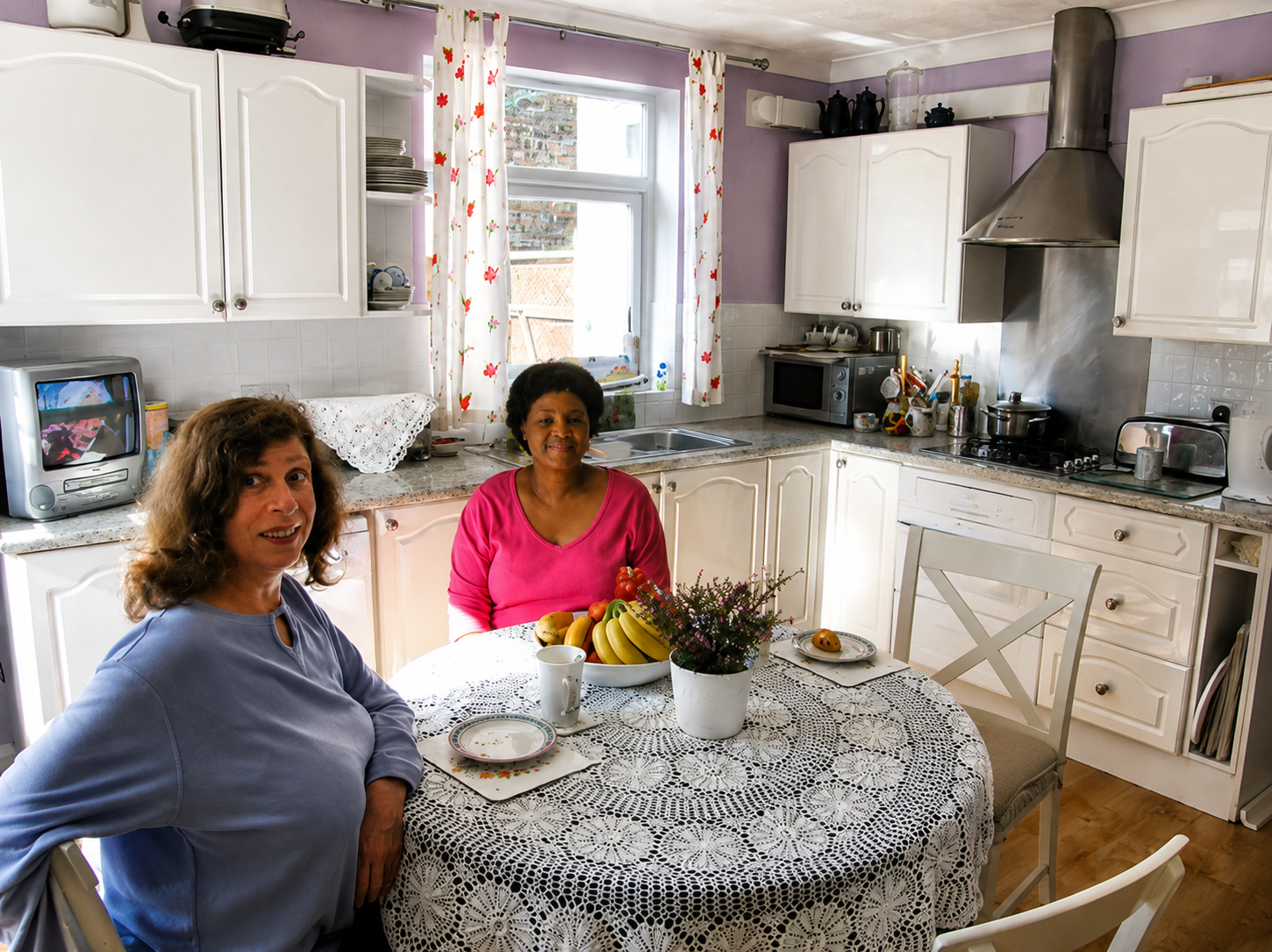 Residents sharing time together in the bright kitchen and dining space.